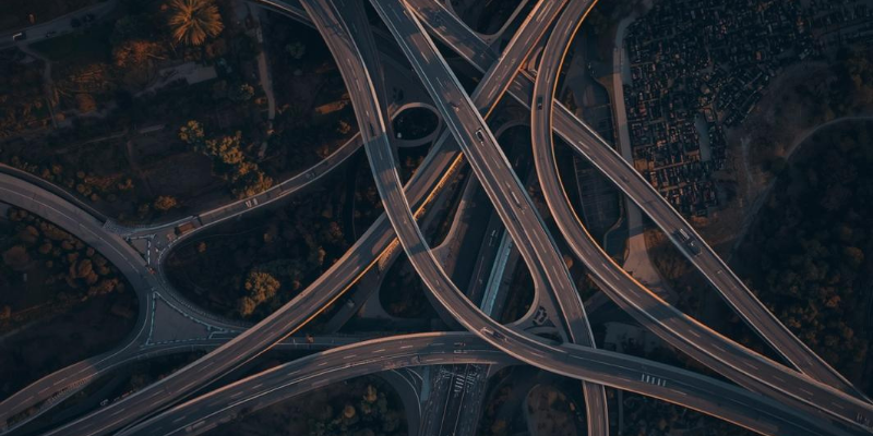 Aerial view of highway interchange at dusk — multiple customer acquisition channels converging